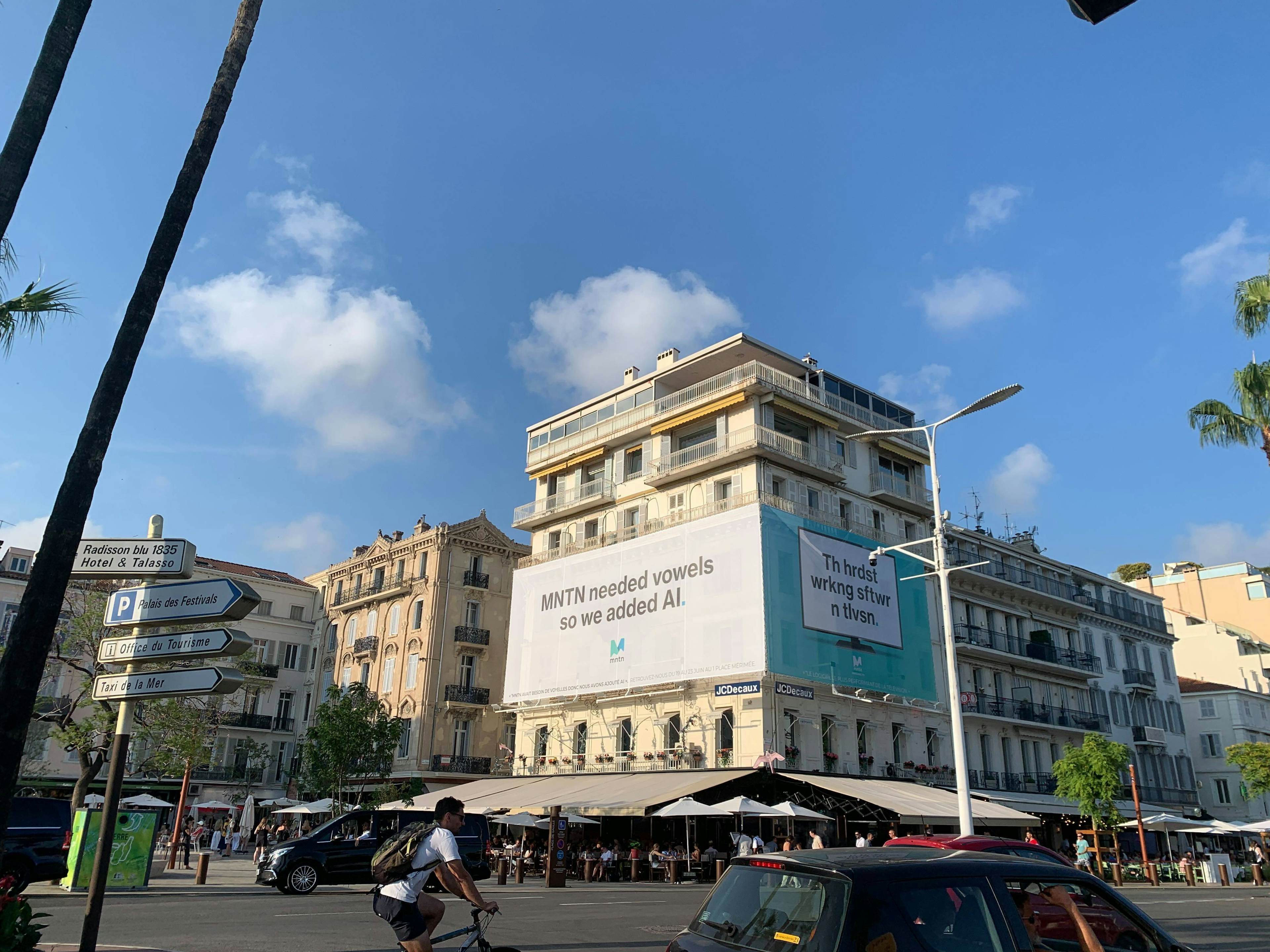 an image of a billboard on the side of a building reading "MNTN needed vowels so we added AI."