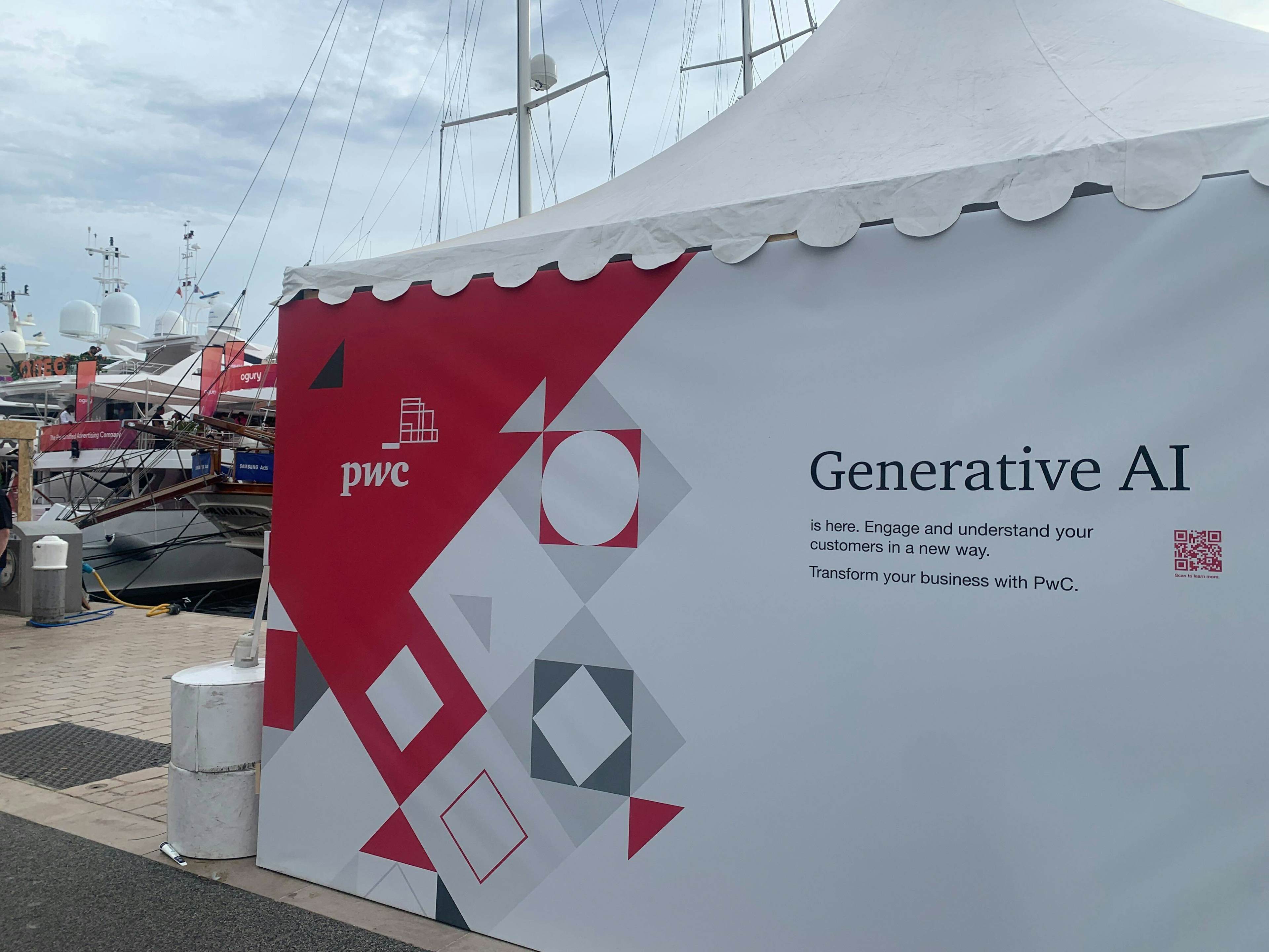 A branded tent for PwC reading "generative AI is here. Engage and understand your customers in a new way. Transform your business with PwC."