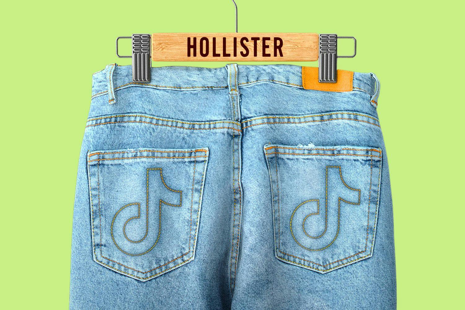 Jeans with TikTok logos on the back pockets hanging on a Hollister branded hanger